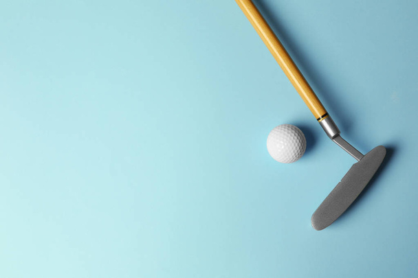 Golf ball and club on light blue background, flat lay. Space for text - Zdjęcie, obraz
