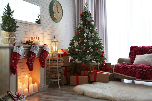 Stylish interior with beautiful Christmas tree and decorative fireplace - Zdjęcie, obraz