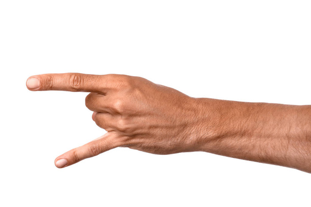Mies käsi osoittaa "paholaisen sarvet" ele valkoisella taustalla
 - Valokuva, kuva
