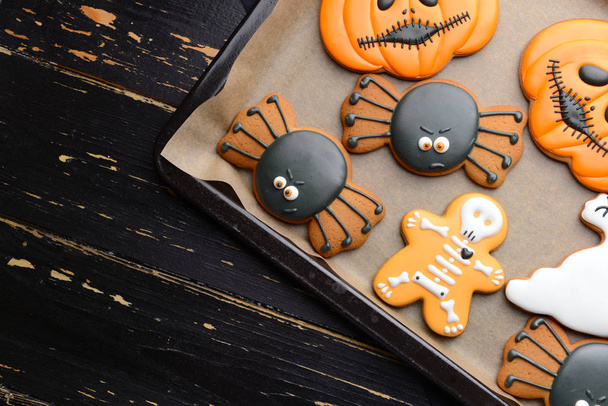 Baking tray with creative Halloween cookies on wooden background - Zdjęcie, obraz