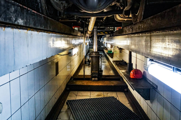 The inspection pit in garage. Water on the floor - Fotoğraf, Görsel