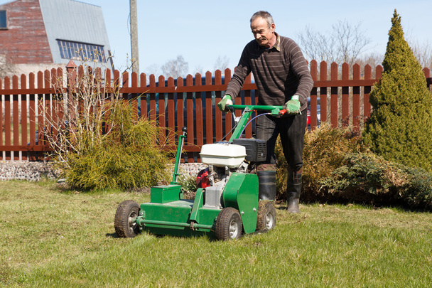 Man working with Lawn Aerator - Photo, Image