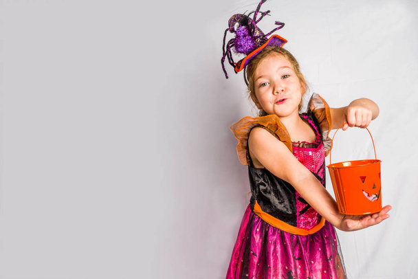 Little cute girl in witch costume for Halloween - Фото, изображение