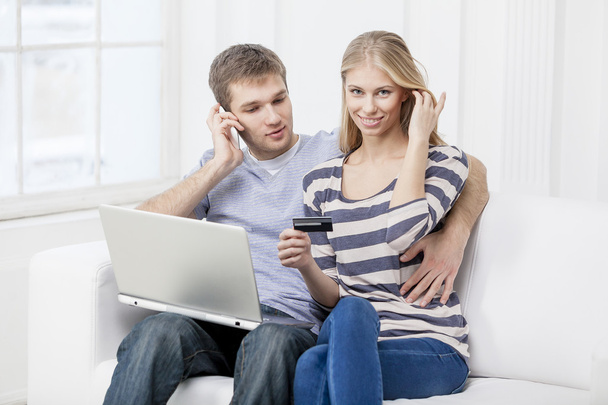 Young caucasian couple sitting on couch - Photo, Image