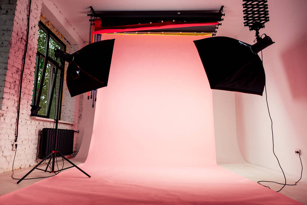 interior photo studio professional equipment, light and pink photobackground - Photo, Image