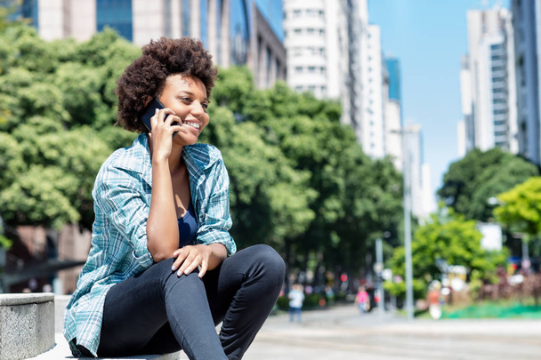 African american young adult talking at phone - Φωτογραφία, εικόνα
