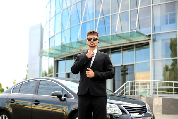Professional bodyguard near car outdoors - Photo, Image