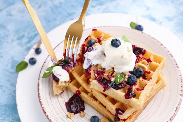 Mangiare gustosi waffle con gelato e mirtilli sul piatto, primo piano
 - Foto, immagini