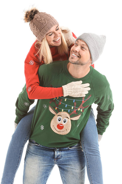 Happy couple in Christmas sweaters on white background - Photo, Image