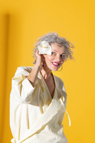 Cheerful beautiful woman with flower in hair smiling - Valokuva, kuva