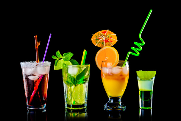 Different tasty cocktails on dark background - Valokuva, kuva