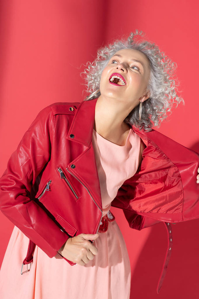 Woman with curly hair laughing while posing in photo shoot - Fotó, kép
