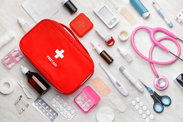 First aid kit on light background - Фото, изображение