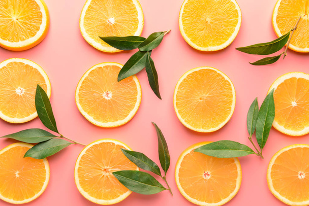Ripe gesneden sinaasappelen op kleur achtergrond - Foto, afbeelding