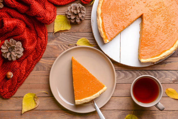Composition with tasty pumpkin pie on wooden table - Photo, Image
