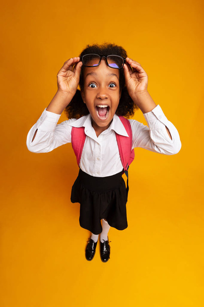 Amazed Afro Schoolgirl Screaming Looking At Camera, High-Angle - 写真・画像