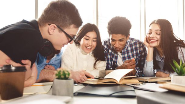 Classmates learning in library at university together - Photo, Image