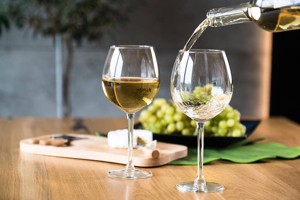 Closeup of pouring white wine in restaurant - Photo, Image