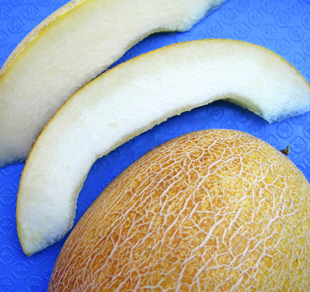 Ripe juicy melon on the blue background. - Photo, Image