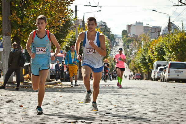 CHERNIVTSI, UKRAINE - SEPTEMBER 29. 2019 : Runners participating in the "Bukovina Mile" charity fun run. A short marathon race to support peace. Family-friendly sports and a healthy lifestyle. - Fotó, kép