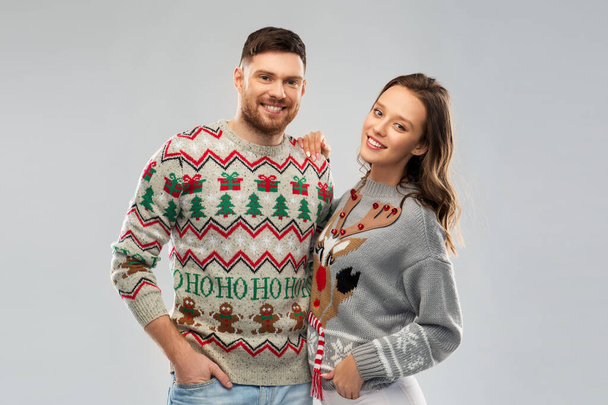 happy couple at christmas ugly sweater party - Фото, изображение