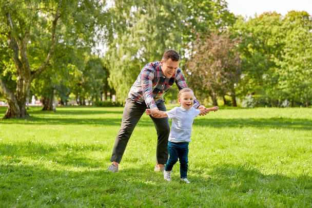 happy father with son playing in summer park - Valokuva, kuva