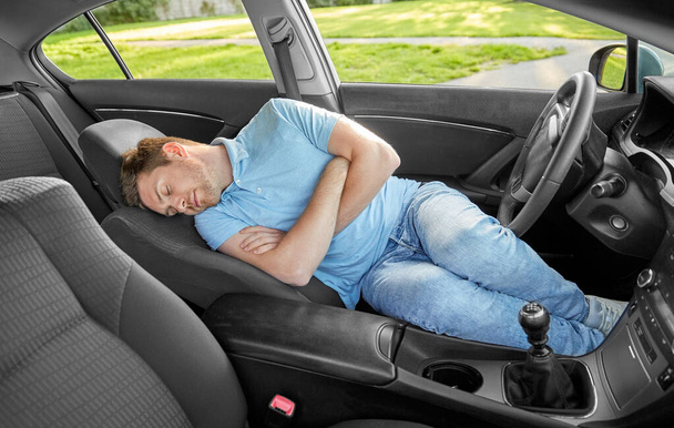 tired man or driver sleeping in car - 写真・画像