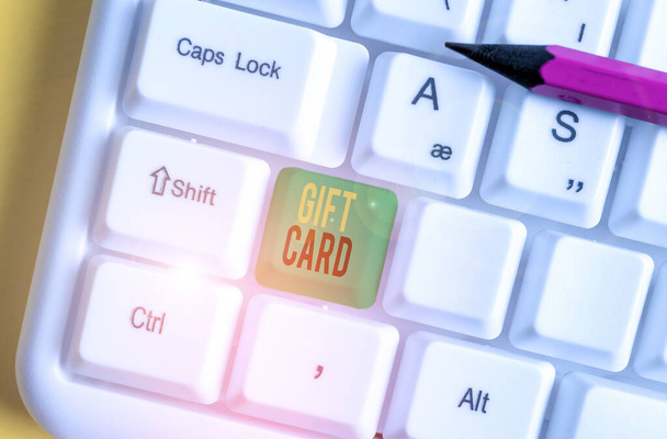 Word writing text Gift Card. Business concept for A present usually made of paper that contains your message White pc keyboard with empty note paper above white background key copy space. - Photo, Image