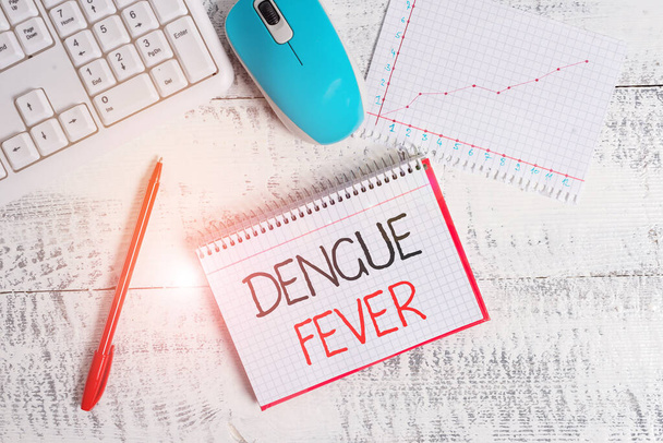 Conceptual hand writing showing Dengue Fever. Business photo text infectious disease caused by a flavivirus or aedes mosquitoes Wood desk office appliance computer equipaments charts paper slot. - Photo, Image
