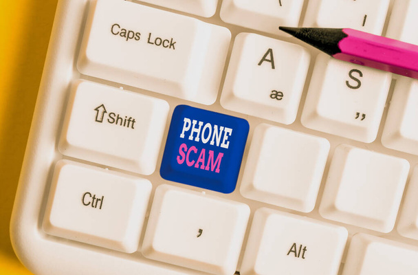 Text sign showing Phone Scam. Conceptual photo getting unwanted calls to promote products or service Telesales White pc keyboard with empty note paper above white background key copy space. - Photo, Image