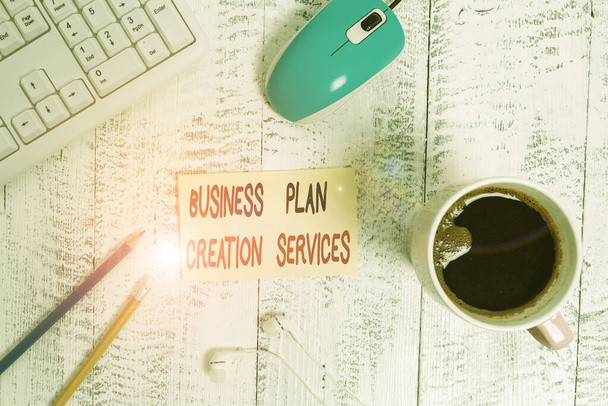 Conceptual hand writing showing Business Plan Creation Services. Business photo text paying for professional to create strategy Technological devices colored reminder paper office supplies. - Photo, Image