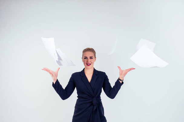 portrait of successful happy business woman glasses blonde hairstyle perfect make-up red lips in stylish black suit throwing paper up in studio white background isolate.freedom of deadline - Foto, afbeelding