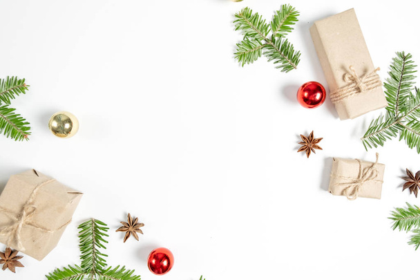 Karácsonyi kézzel készített ajándékdobozok díszített kézműves papír és ág fehér háttérrel. Karácsony, tél, újévi koncepció. Lapos fekvés, felülnézet, másolás - Fotó, kép