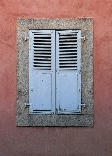 Blue shutters on window red wall Argentiere French Alps - Photo, Image