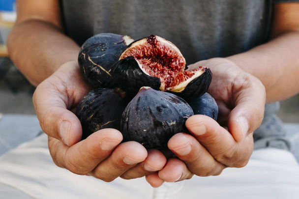 man with some figs in his hands - Photo, Image