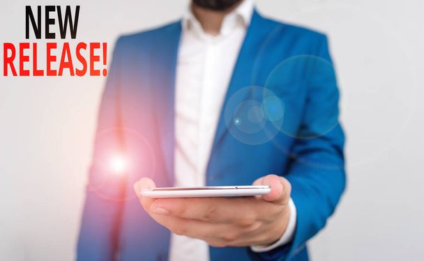 Word writing text New Release. Business concept for announcing something newsworthy recent product Business concept with man holding mobile phone with touch screen. - Photo, Image