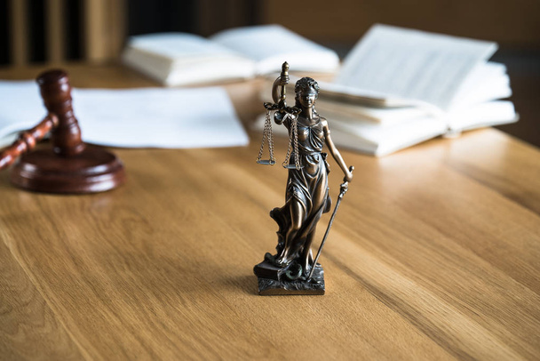 Law and Justice, Statue of blind goddess Themis on wooden table with blurred background. - Fotó, kép
