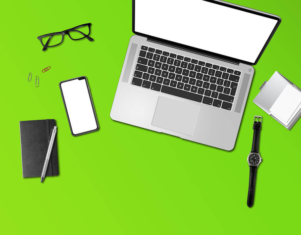 Office desk mockup top view isolated on green - Foto, Bild