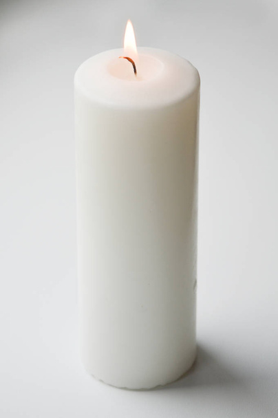 white candle on a light background. white. a large candle. - Foto, immagini