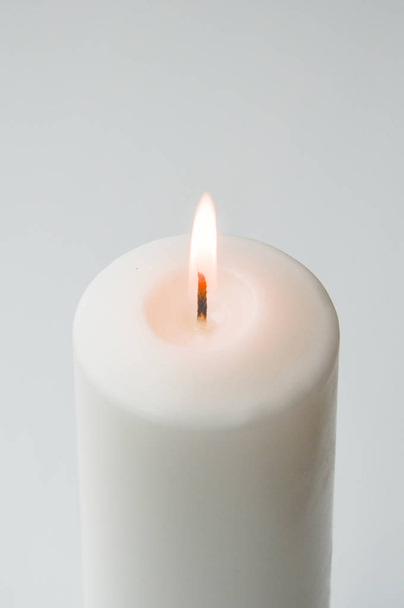 white candle on a light background. white. a large candle. - Foto, immagini