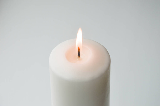 white candle on a light background. white. a large candle. - Φωτογραφία, εικόνα