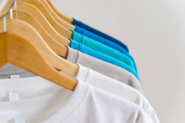 Close up of Colorful t-shirts on hangers, apparel background - Valokuva, kuva