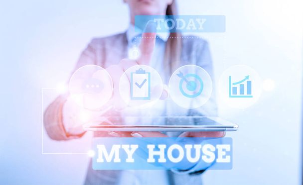 Text sign showing My House. Conceptual photo A place or building where i live with the showing whom i loved Female human wear formal work suit presenting presentation use smart device. - 写真・画像