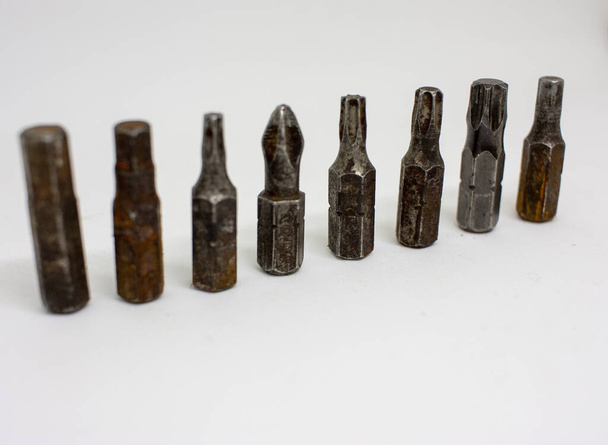 Old, rusty screwdriver bits on a white background. Close-up. - Photo, Image