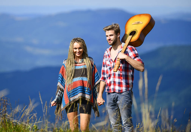 Deep in love. couple in love spend free time together. western camping. hiking. happy friends with guitar. friendship. campfire songs. country music. romantic date. men play guitar for girl - Фото, зображення