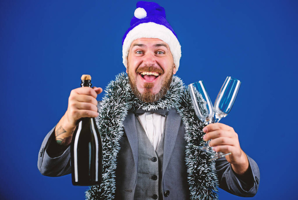 Christmas party organisers. Boss tinsel ready celebrate new year. Corporate party ideas employees will love. Corporate christmas party. Man bearded cheerful hipster santa hold champagne and glasses - Photo, Image