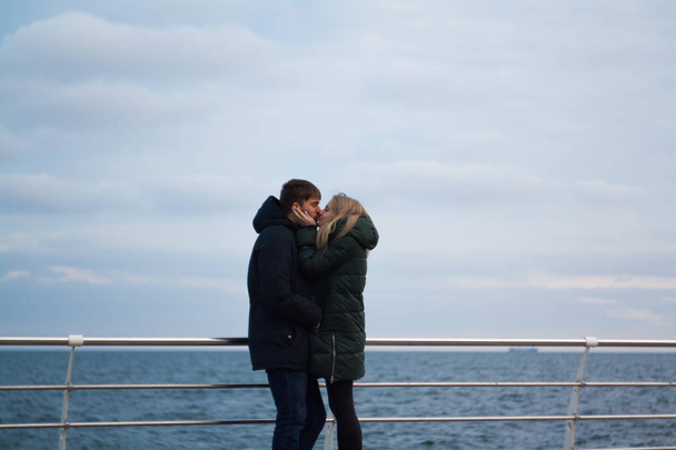 winter love story. couple in the sea - 写真・画像