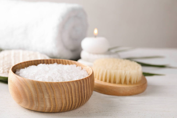 White sea salt for spa scrubbing procedure on wooden table - Zdjęcie, obraz