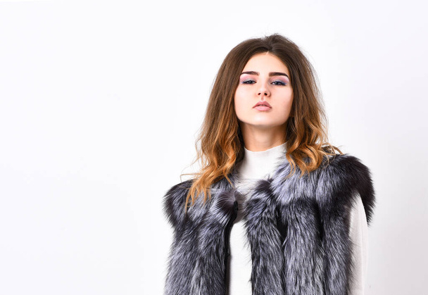 Boutiques selling fur. Woman makeup face wear fur vest white background. Silver fur vest fashion clothing. Luxury fur accessory clothes. Fashion trend concept. Winter fashionable wardrobe for female - Photo, Image