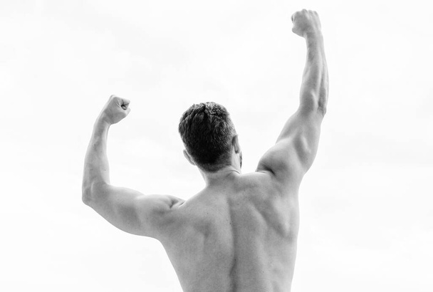 Victory and success. Champion and winner concept. Man celebrating success. Bodybuilder strong muscular body feeling powerful and superior rear view. Achieve success. Great shape. Successful athlete - Fotoğraf, Görsel